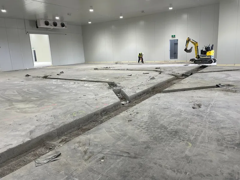 Concrete broken out with a hydraulic breaker and cleared from the work area.