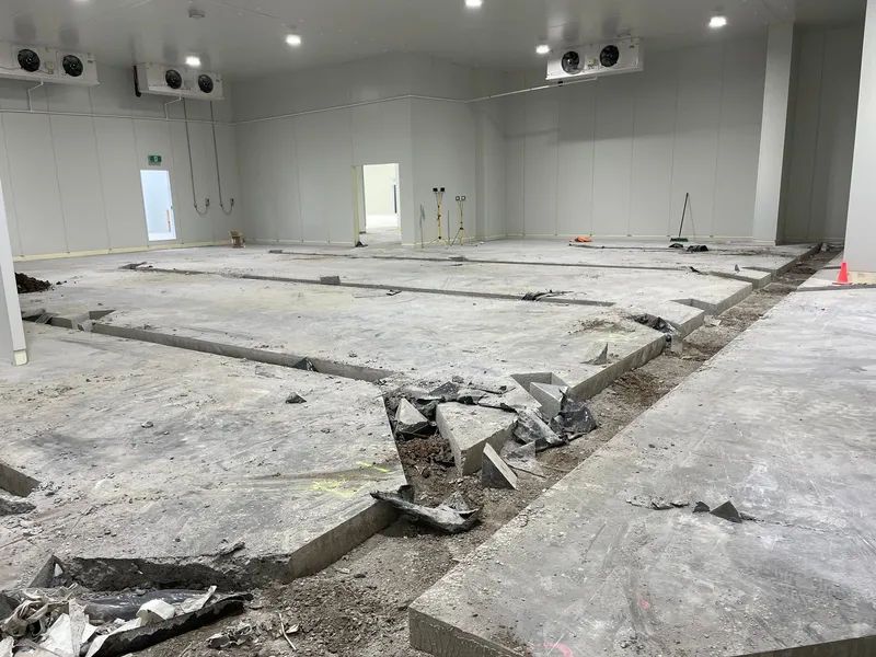 Trench dug through the exposed ground ready for new services to be run.