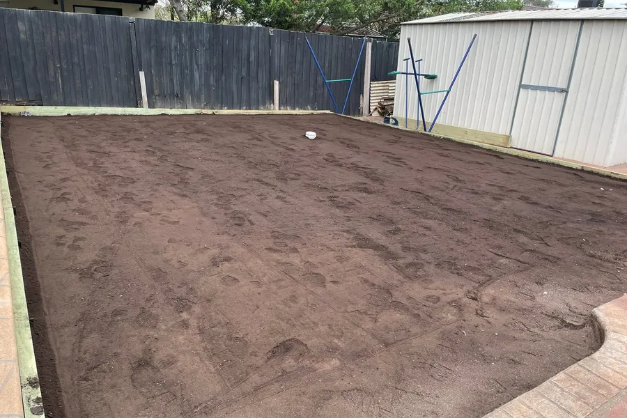A skid-steer loader grading a residential block level in Melbourne's outer west.