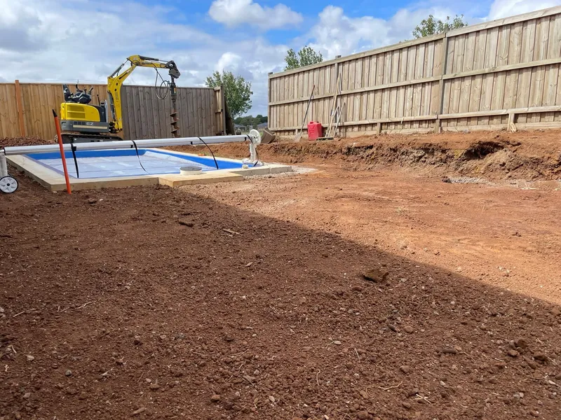 Finished graded pad with fall to drainage, ready for landscaping.